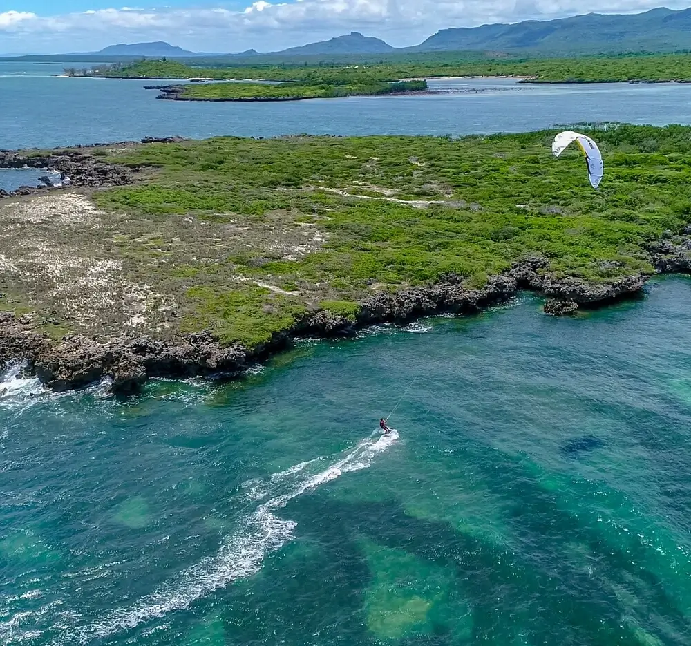 A kite surfer glides above the ocean waves