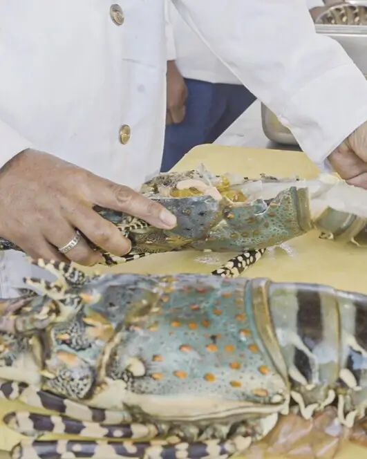 Chefs preparing fresh fish in kitchen