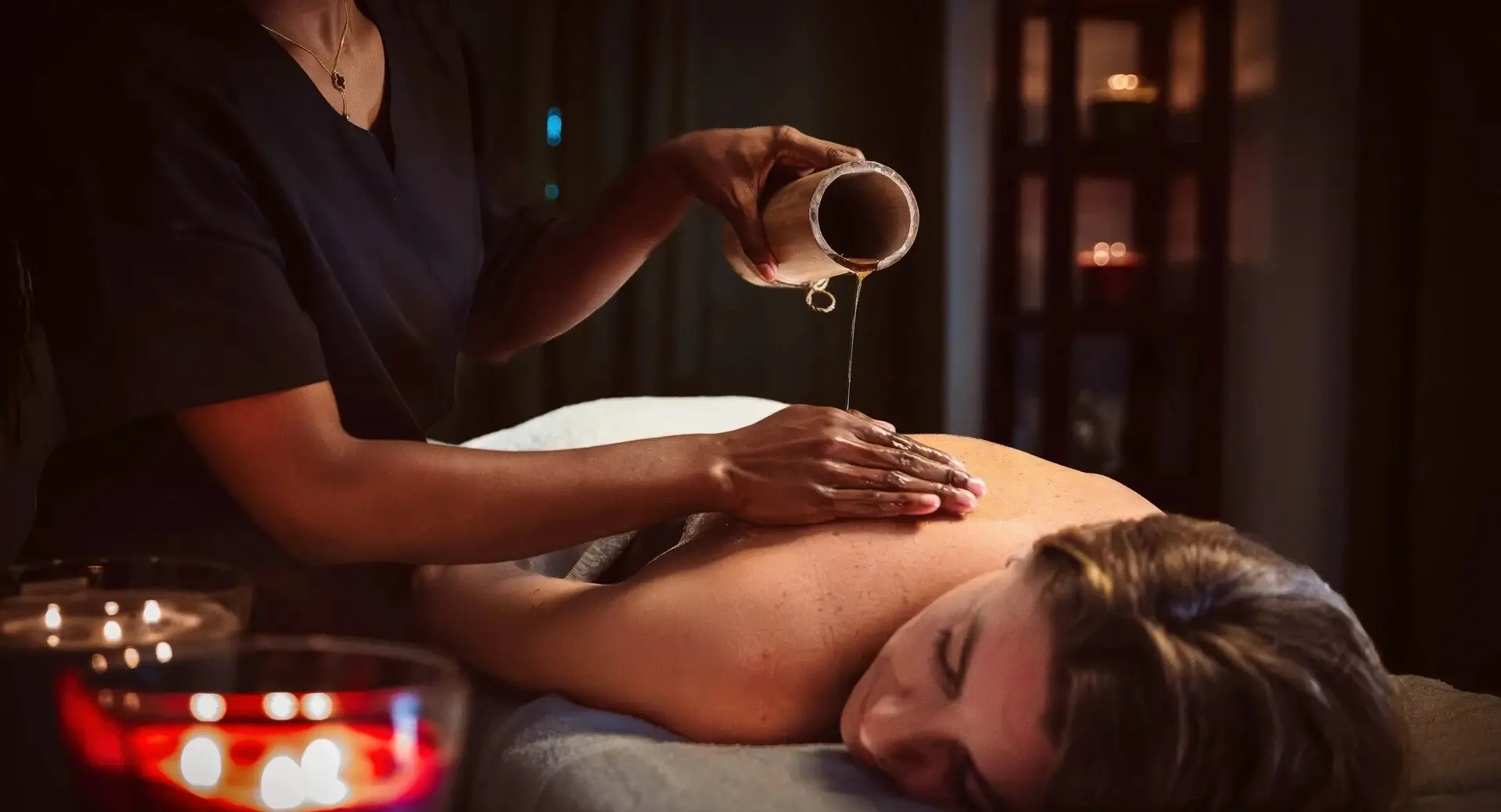 A woman receiving a relaxing oil massage on her back